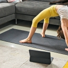 Young girl exercising whilst mother works from home